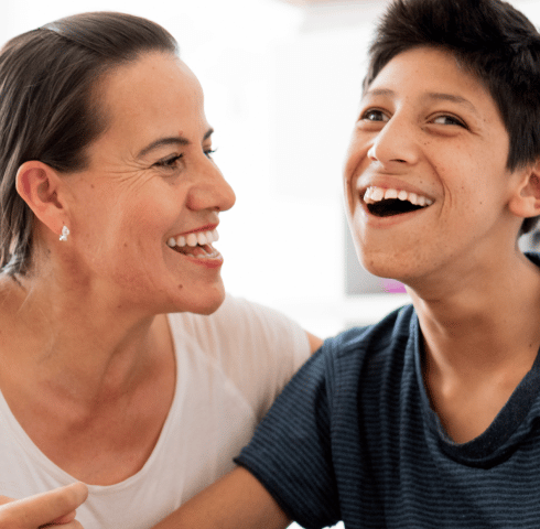 Teen and mum laughing together