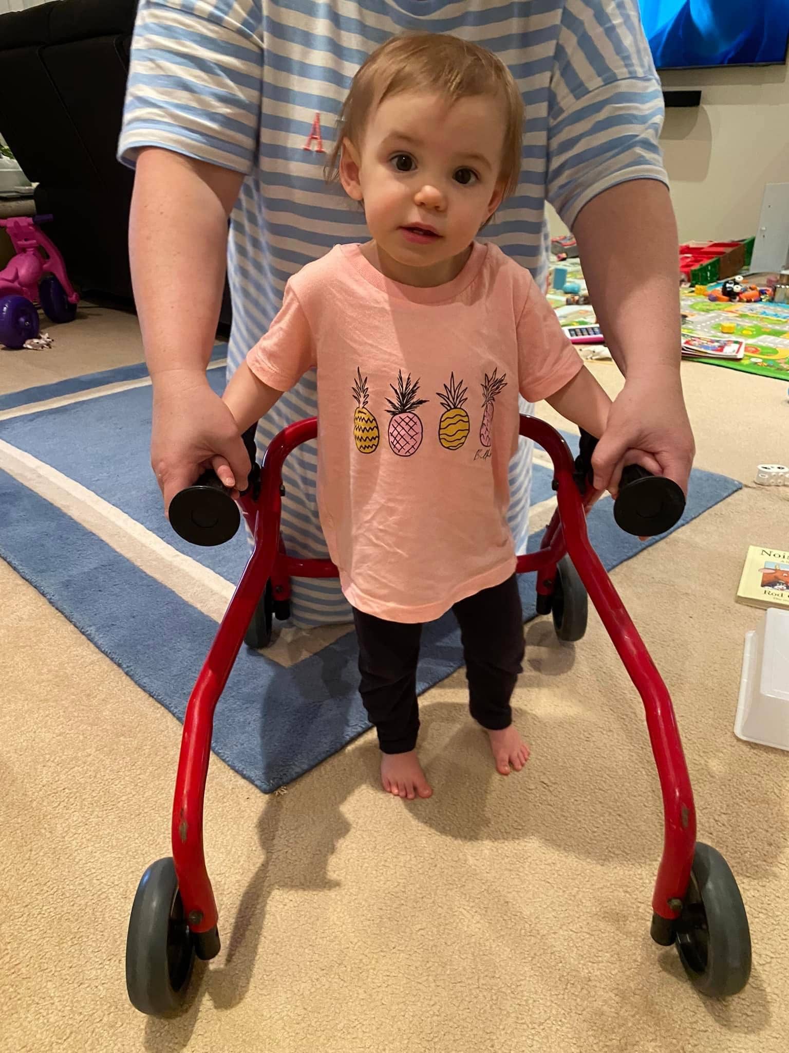 Eloise happy and learning to walk with her walking frame