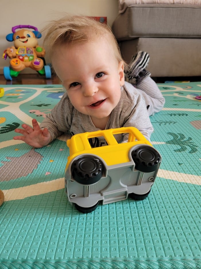 Leo baby on floor with toy car